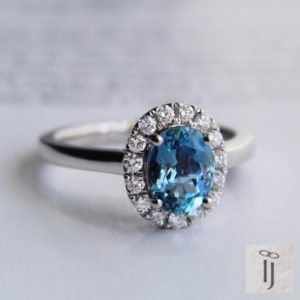 Oval sapphire and diamond cluster ring